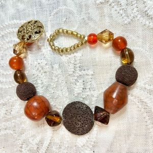 9” boho style bracelet in oranges, browns, and golds. These are great stackables